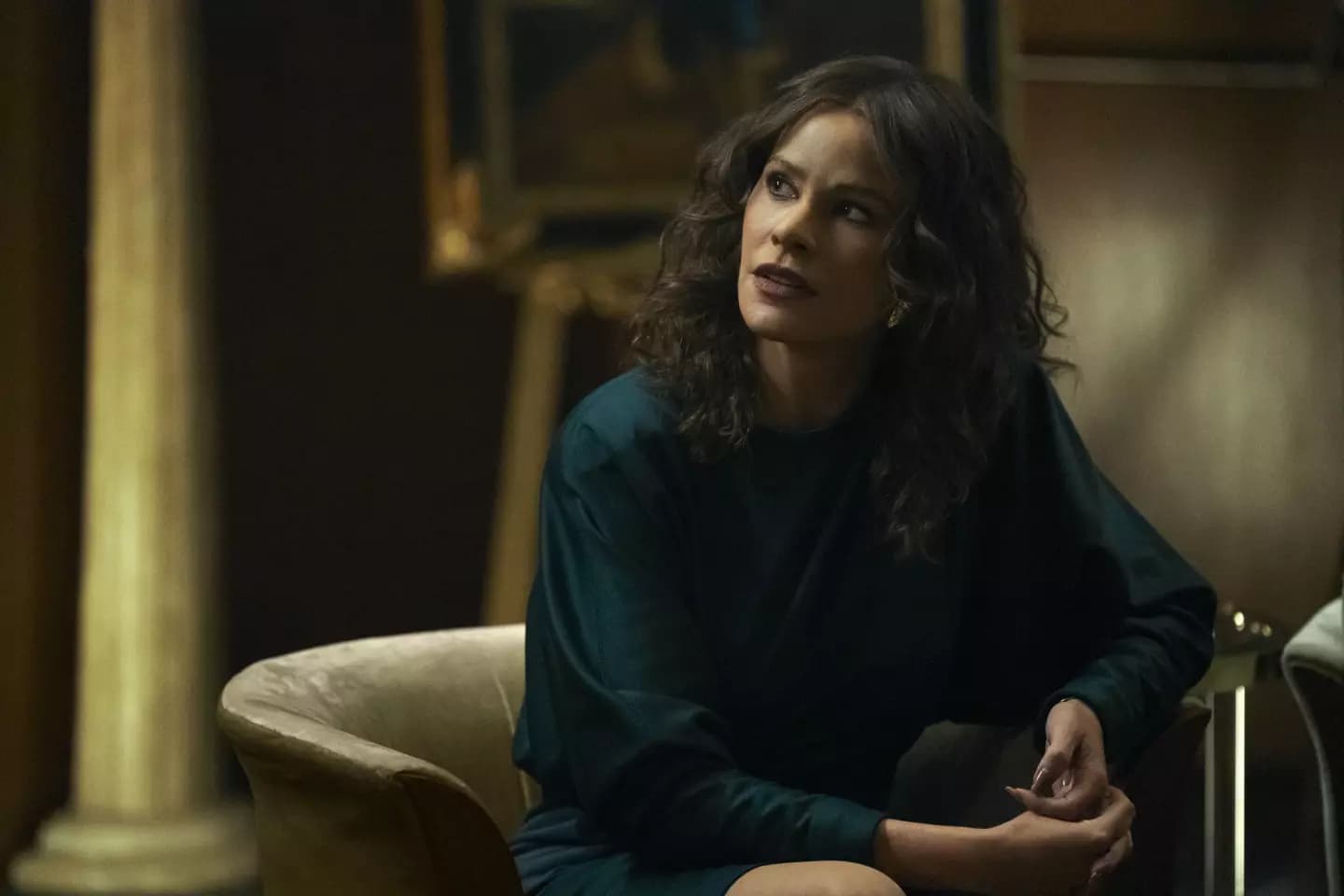 Sofía Vergara as Griselda Blanco sitting on a couch in Netflix’s Griselda.
